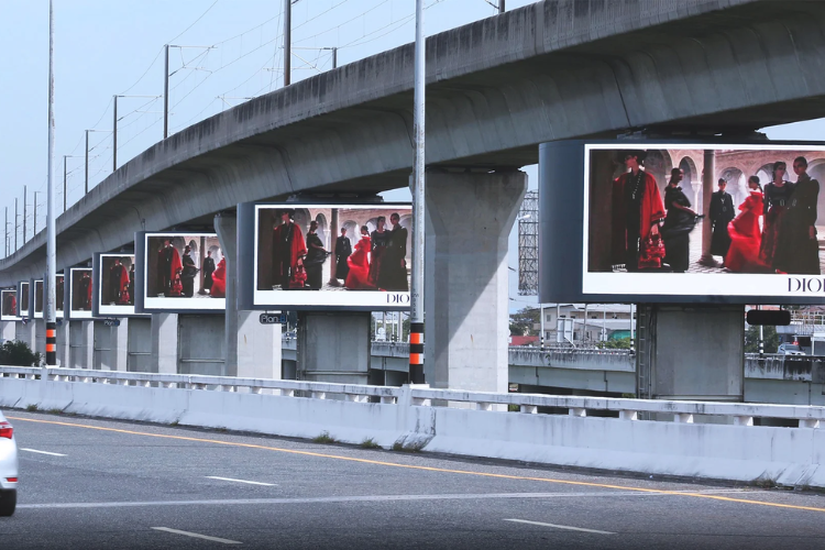 Which companies manage outdoor ad campaigns from design to installation?